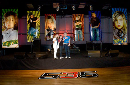 Banner Signs: The Band 535 in front of their banners and floor graphic.