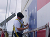 Shadow Graphics' 3M certifed installer applying exterior wall mural at 350ft